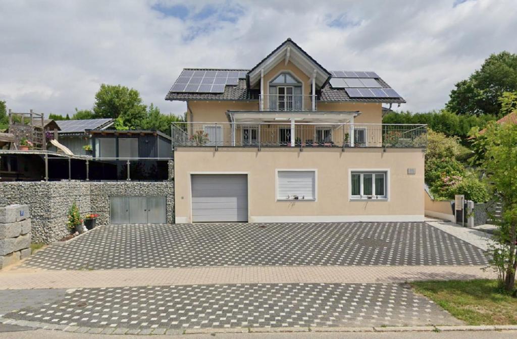 a house with solar panels on the roof at Ferienwohnung Fernblick in Neukirchen vorm Wald