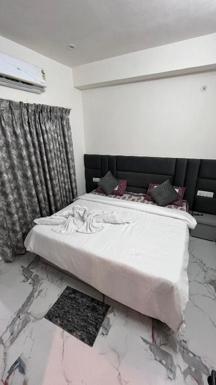 a bed in a room with a marble floor at Millennium Suites in Orchha