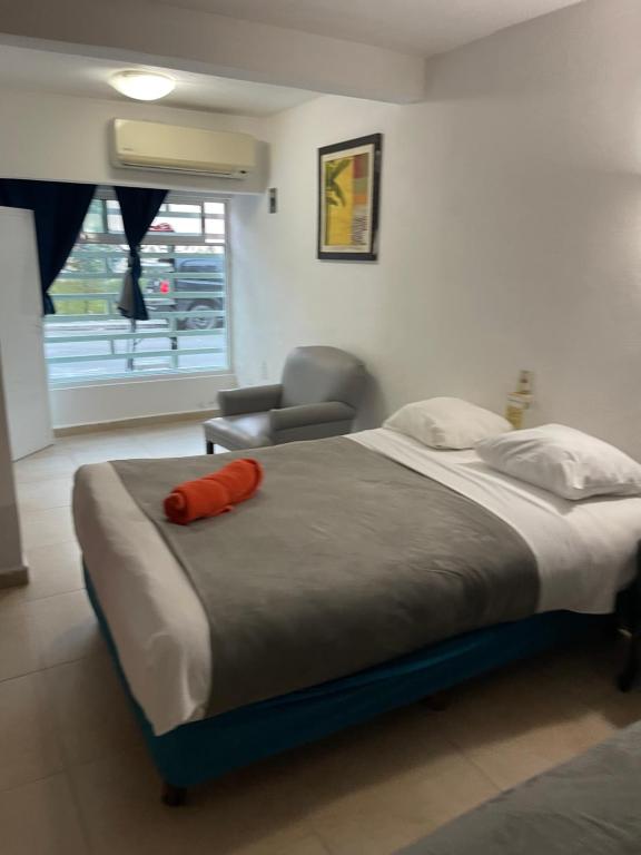 a bedroom with a bed with a red pillow on it at CONDO Marena 2 in Playa del Carmen