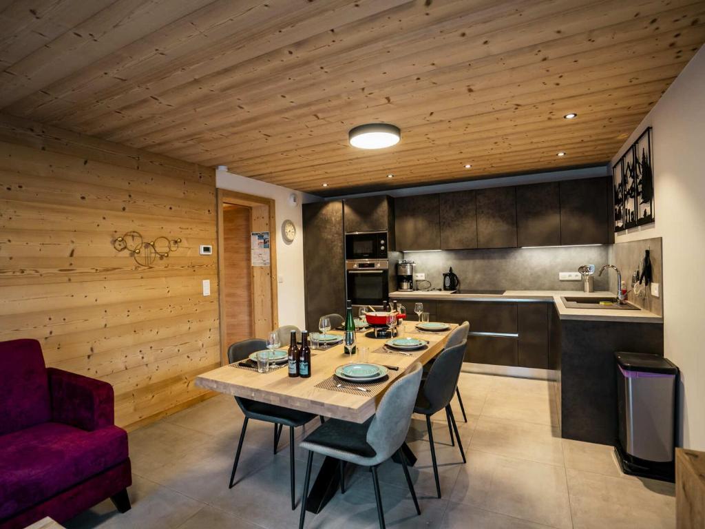 une cuisine avec une table et des chaises dans une pièce dans l'établissement Appartement neuf 3* pour 6 pers., terrasse, parking, proche centre et remontées, Châtel - FR-1-676-192, à Châtel