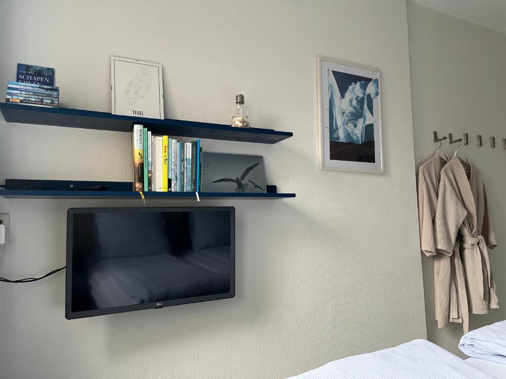 Postel nebo postele na pokoji v ubytování B&B Vloedlijn Texel