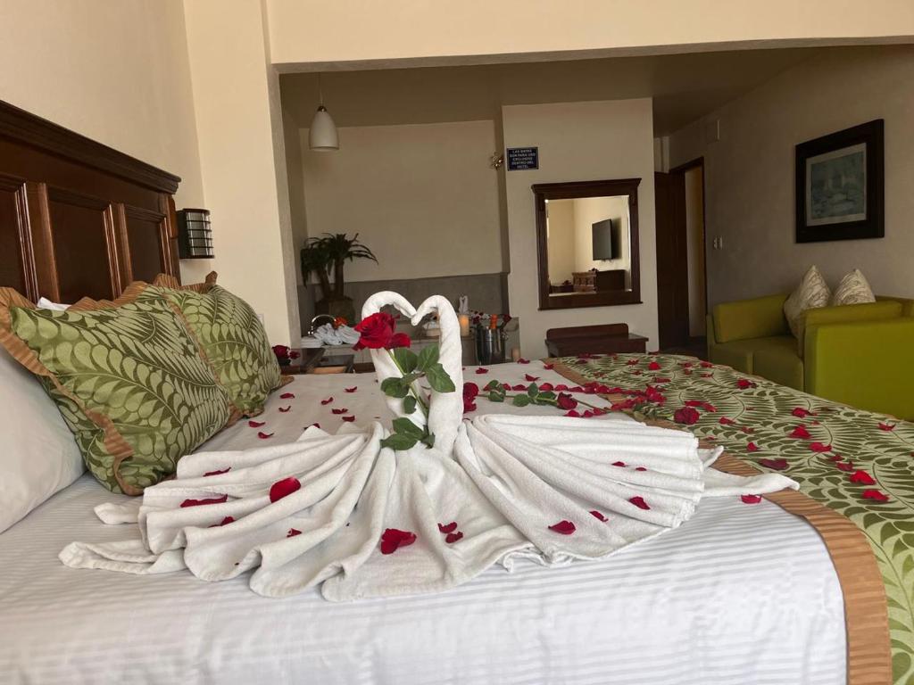 a wedding dress on top of a bed at Hotel San Carlos Tequisquiapan in Tequisquiapan