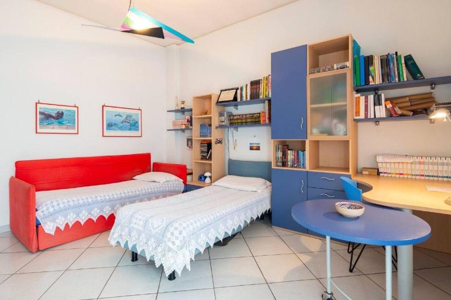 a living room with a red couch and a table at Home sweet home in Nocera Inferiore