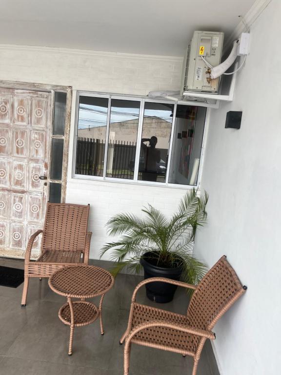 two chairs and a table on a patio at Casa condomínio jardim Moncoes in Maringá