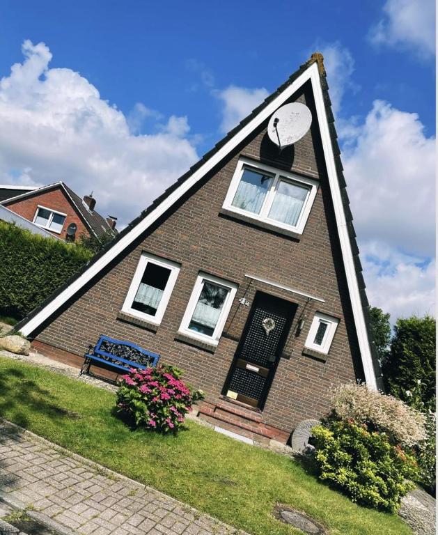 a house with a clock on the top of it at Ferienhaus Liesel in Dornumersiel