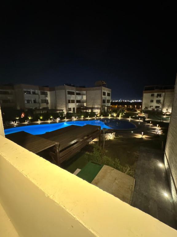 a view of a swimming pool at night at Helnan portfouad hotel in Chantier Island