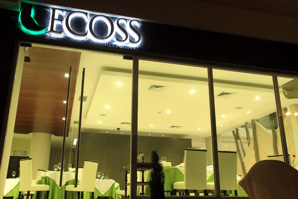 a restaurant with a neon sign on the front of it at Ecohotel Talca in Talca