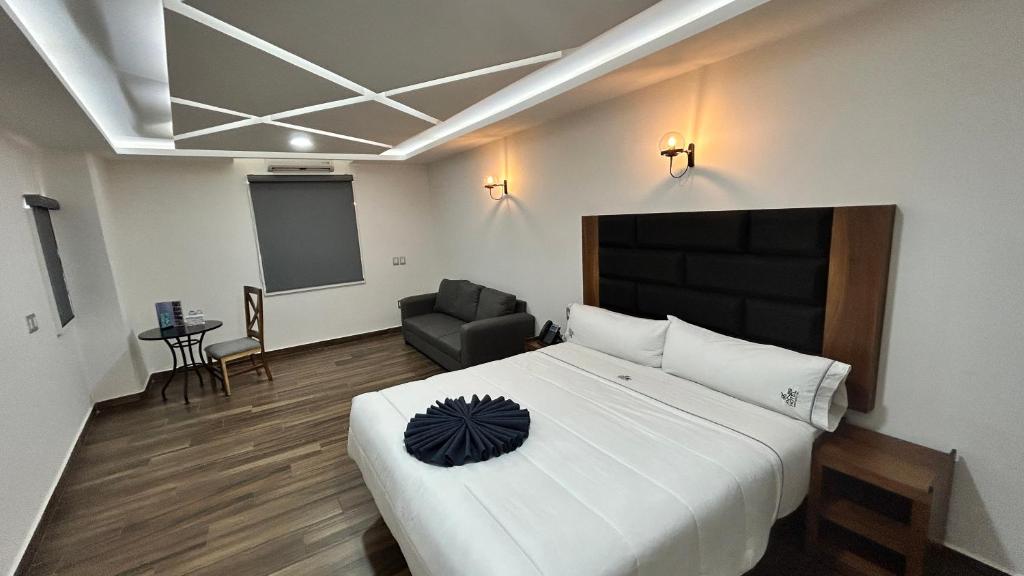 Postel nebo postele na pokoji v ubytování Hotel ANB Aeropuerto Guadalajara