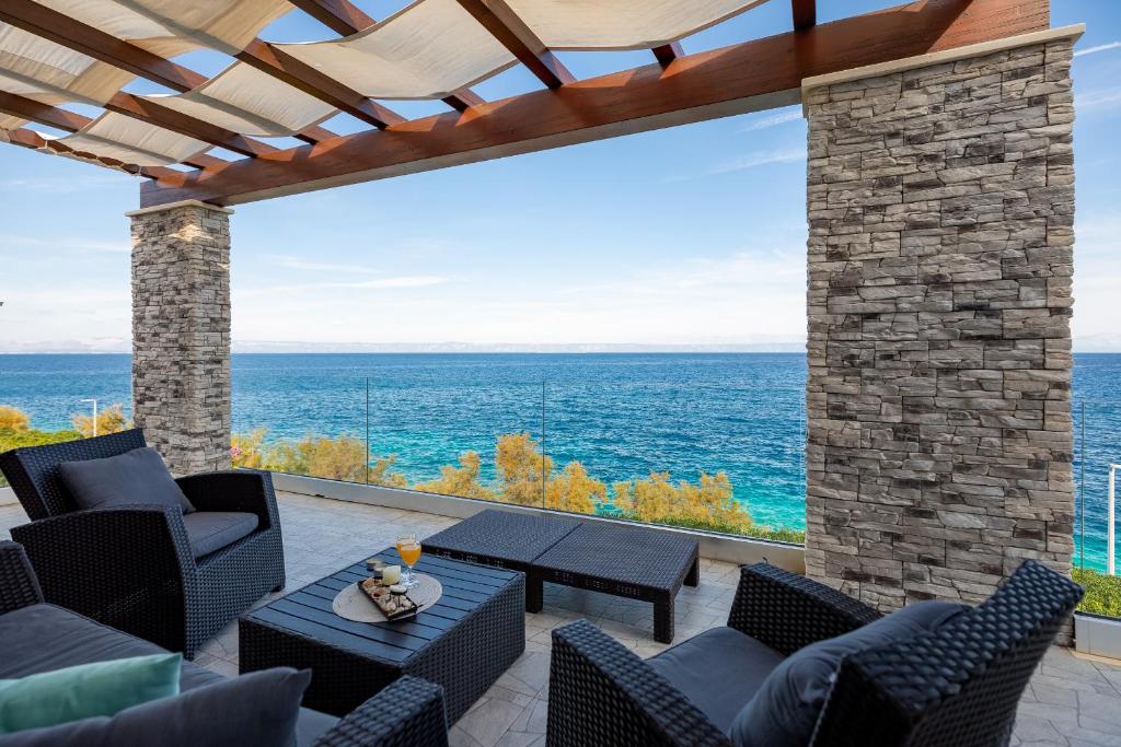a patio with a view of the ocean at Holiday house Martinović in Prigradica
