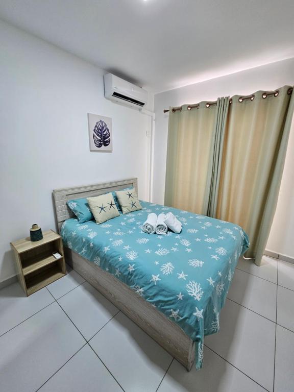 Postel nebo postele na pokoji v ubytování Villa Azure Flic-en-Flac 5 min de la plage