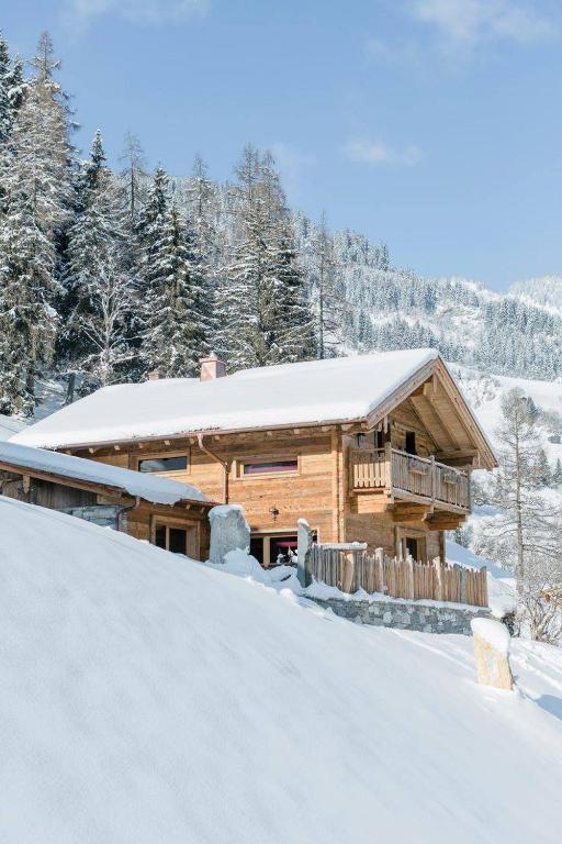 a log cabin in the snow with snow at Chalet Wildberg in Grossarl