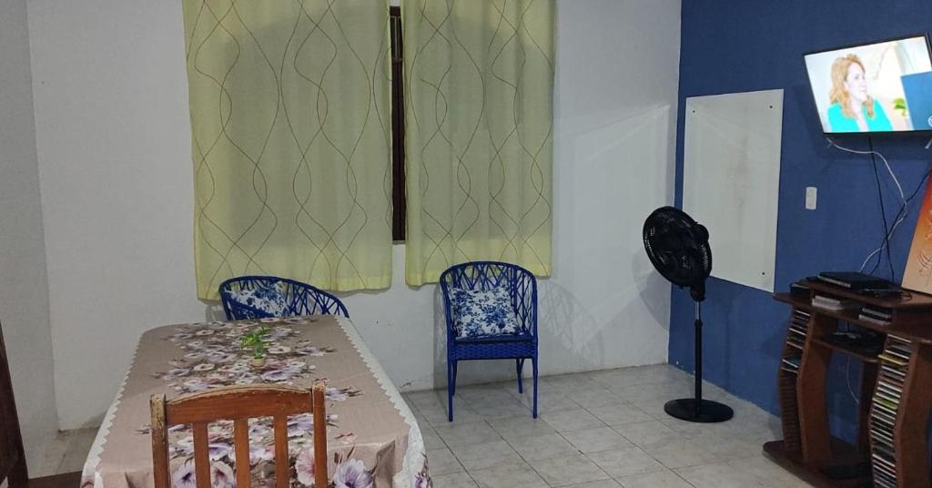 a dining room with a table and two chairs at Casarão Farol da Marise Sol in Belém