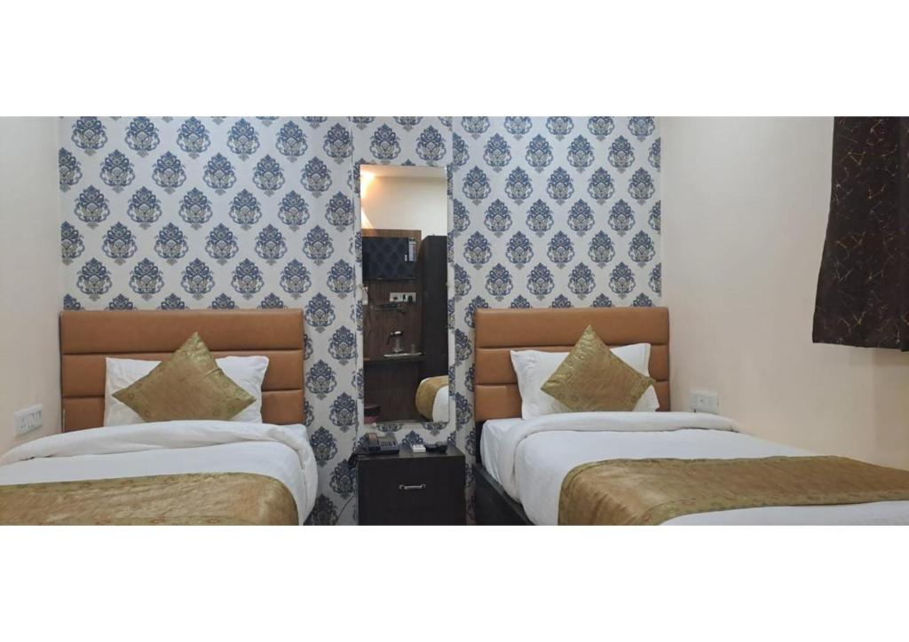 Postel nebo postele na pokoji v ubytování Hotel Shilva Inn