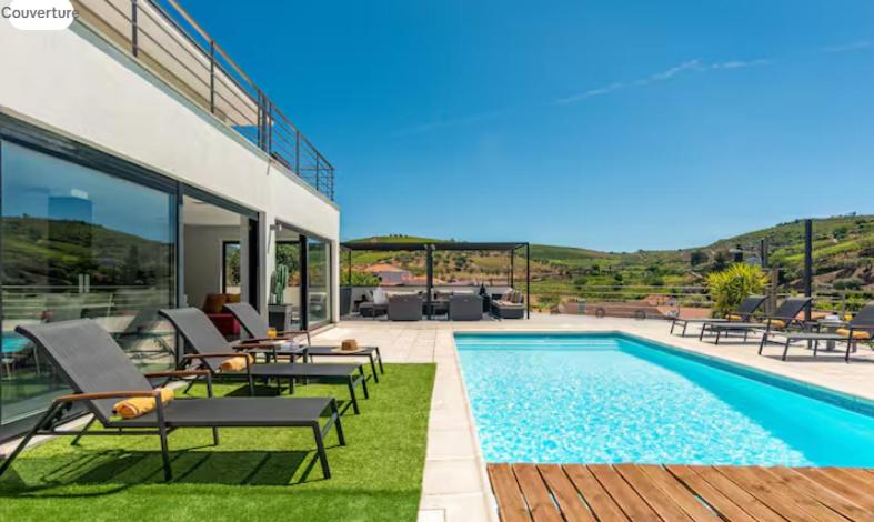 a villa with a swimming pool and a patio at Amazing Villa in Douro Valley - Pool in Espinhosa