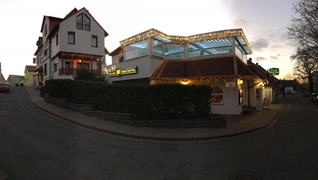 a building with a sign on the side of a street at Hotel & Restaurant Park Cafe ISA in Erfurt