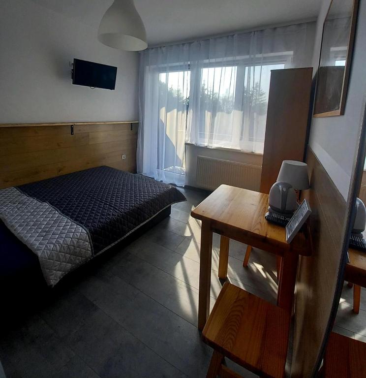 Postel nebo postele na pokoji v ubytování Leśne Zacisze