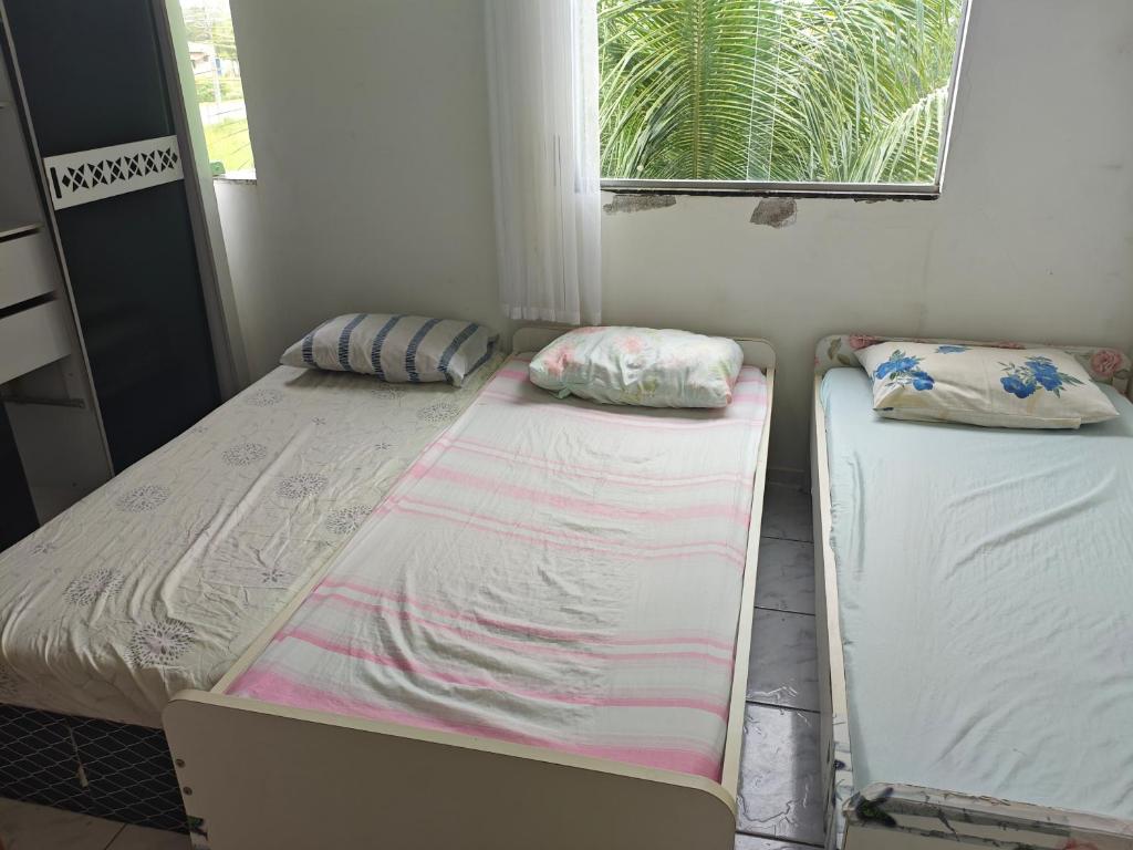 Postel nebo postele na pokoji v ubytování Casa em Guriri para temporada