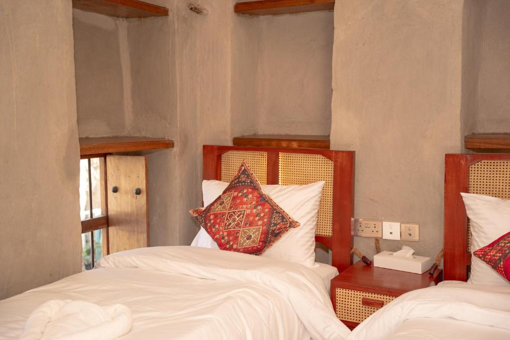 Postel nebo postele na pokoji v ubytování Nomad Inn Nizwa