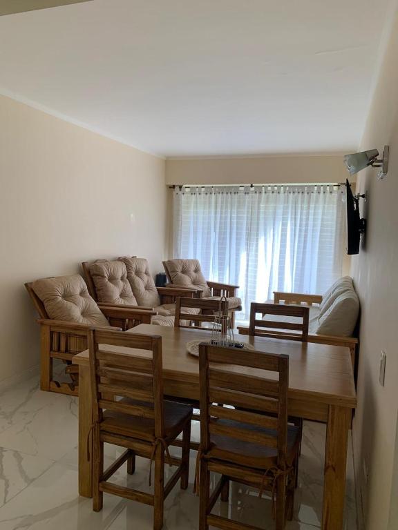 a living room with a table and chairs and a couch at DEPARTAMENTO DOS AMBIENTES APTO 4 Personas in Mar del Plata
