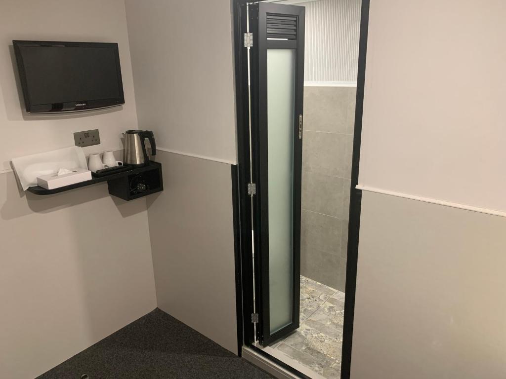 A television and/or entertainment centre at MK STAY - formerly HOTEL MK
