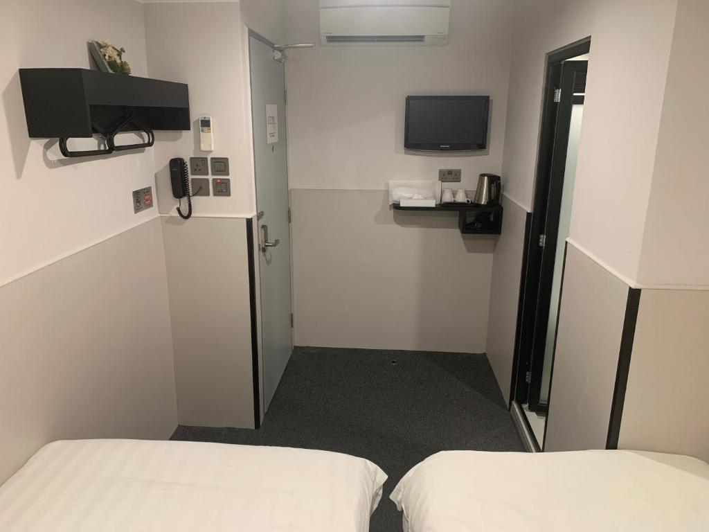 A television and/or entertainment centre at MK STAY - formerly HOTEL MK