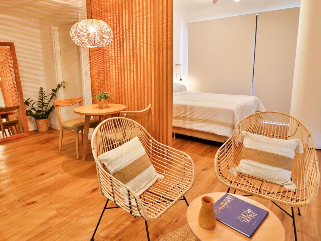 a room with two chairs and a bed and a table at Modern & Bright Studio in Asuncion
