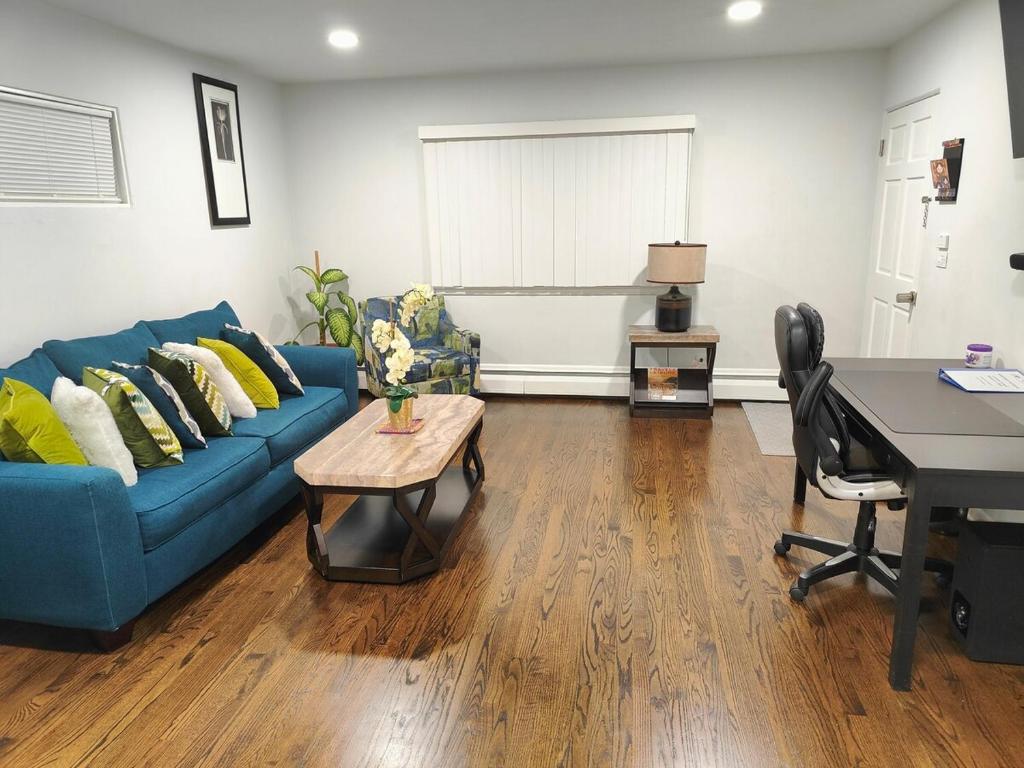 a living room with a blue couch and a table at Coloful - Cozy - 1-BR & Sofa-bed in Waukegan