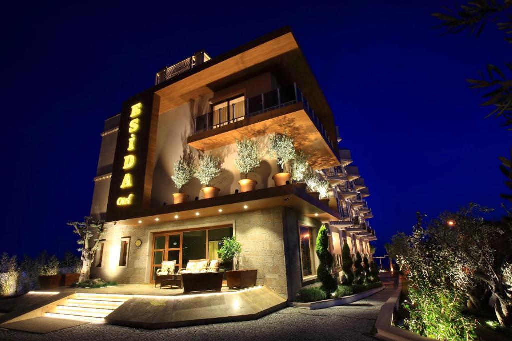 a building with a lit up facade at night at Esida Hotel in Kucukkuyu