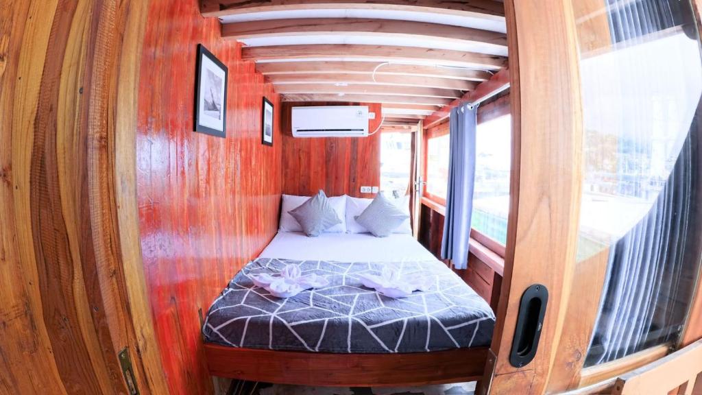 a small bed in the middle of a room at Komodo cruise in Labuan Bajo