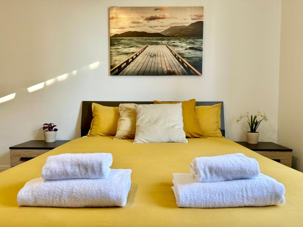 a yellow bed with two white pillows on it at Sergio I Apartment in Rome