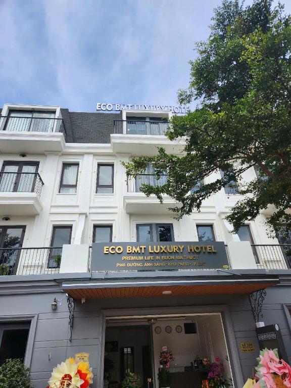 a building with a sign that reads ego bent luxury hotel at Eco BMT LUXURY HOTEL in Buon Ma Thuot