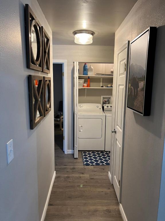 a hallway of a kitchen with a washer and dryer at Renovated condo steps from Beaver Creek shuttle in Avon