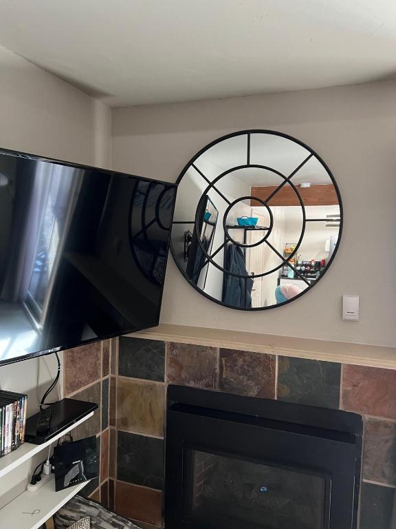 a mirror over a fireplace in a living room at Renovated condo steps from Beaver Creek shuttle in Avon