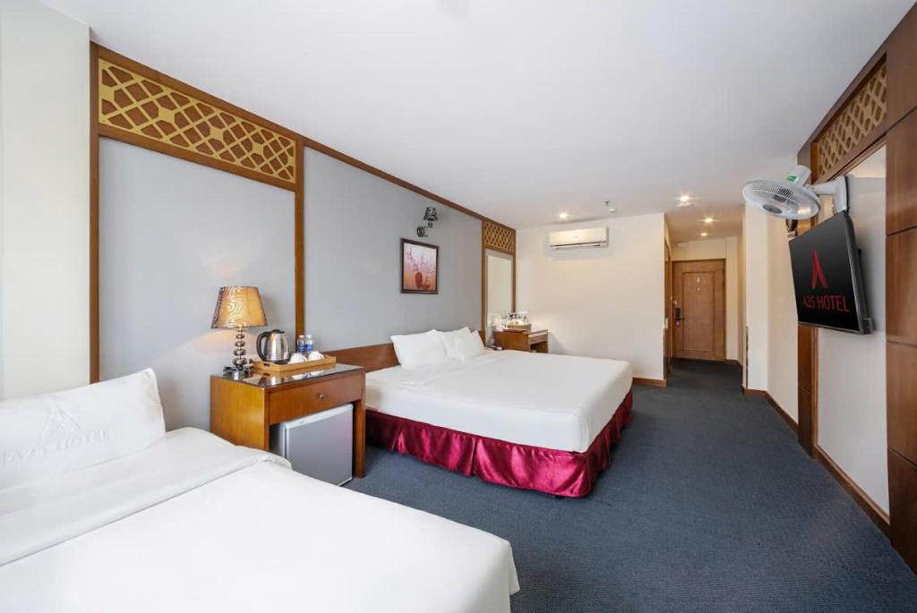 Postel nebo postele na pokoji v ubytování A25 Hotel - 23 Quán Thánh