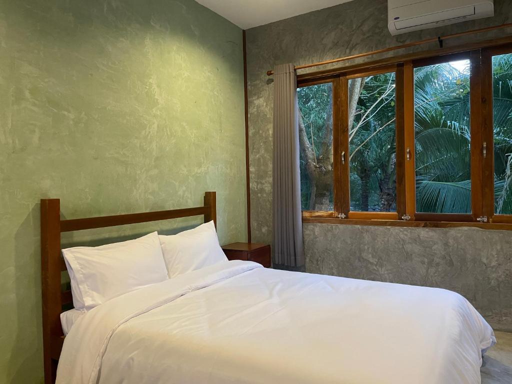Postel nebo postele na pokoji v ubytování COCO HOME Homestay(โคโค่โฮม)