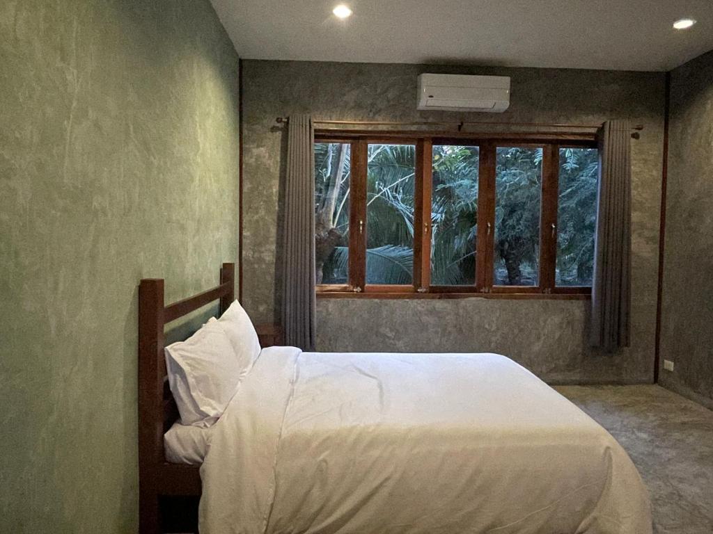 Postel nebo postele na pokoji v ubytování COCO HOME Homestay(โคโค่โฮม)