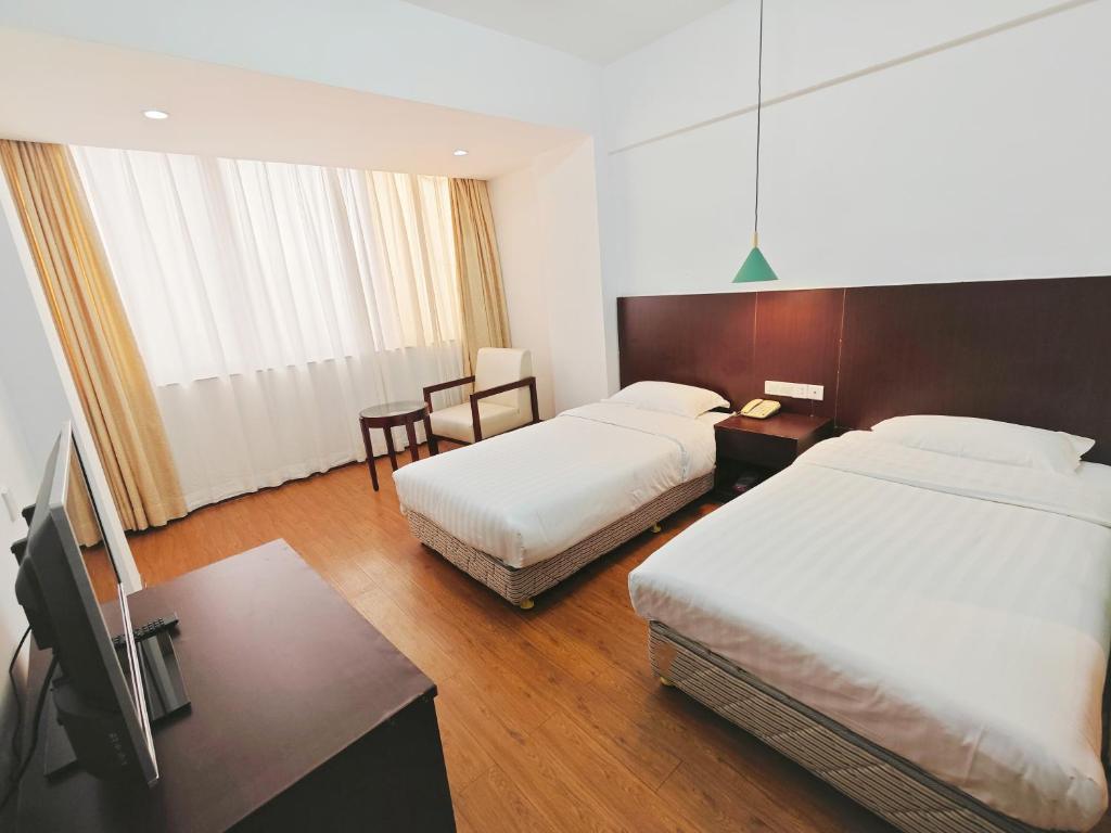 Postel nebo postele na pokoji v ubytování Shenzhen Xinghua Hotel