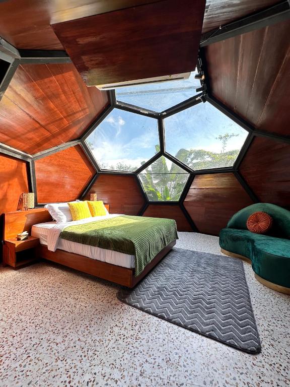 a room with a bed and a large window at Karuna Villa Prambanan in Yogyakarta