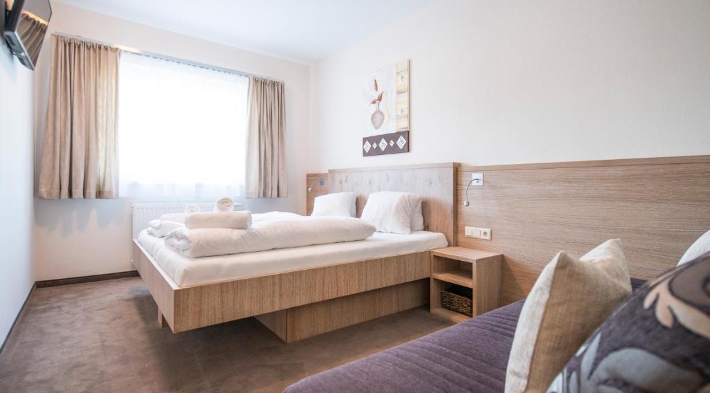 A bed or beds in a room at Crystls Aparthotel