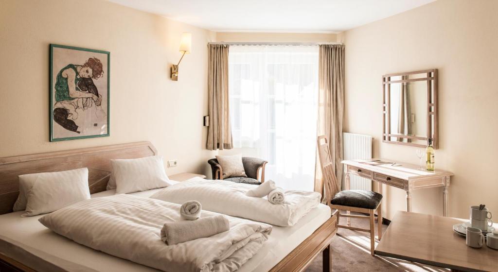 A bed or beds in a room at Crystls Aparthotel