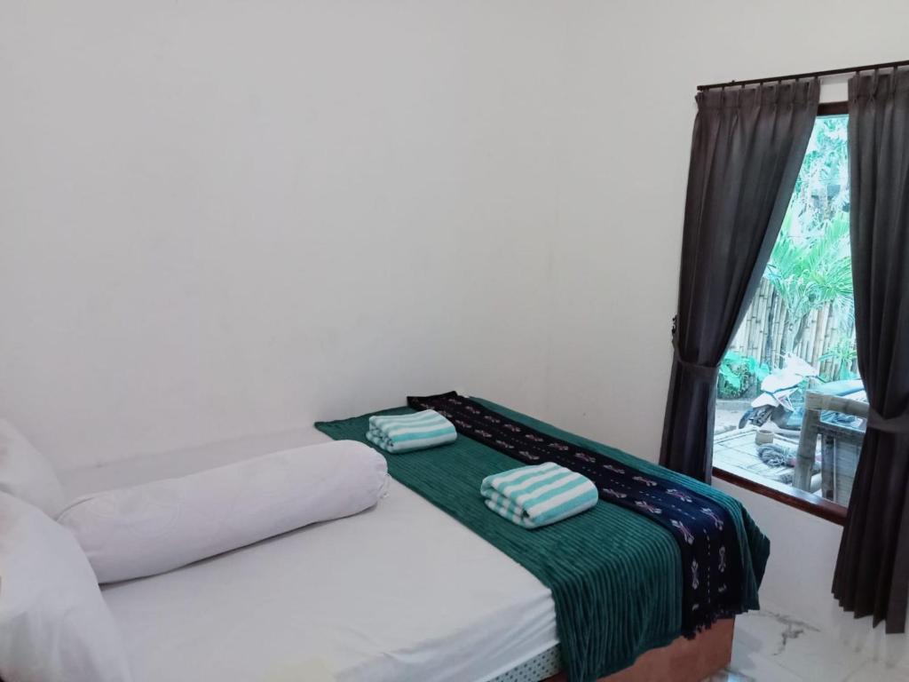 Postel nebo postele na pokoji v ubytování Marsha Homestay