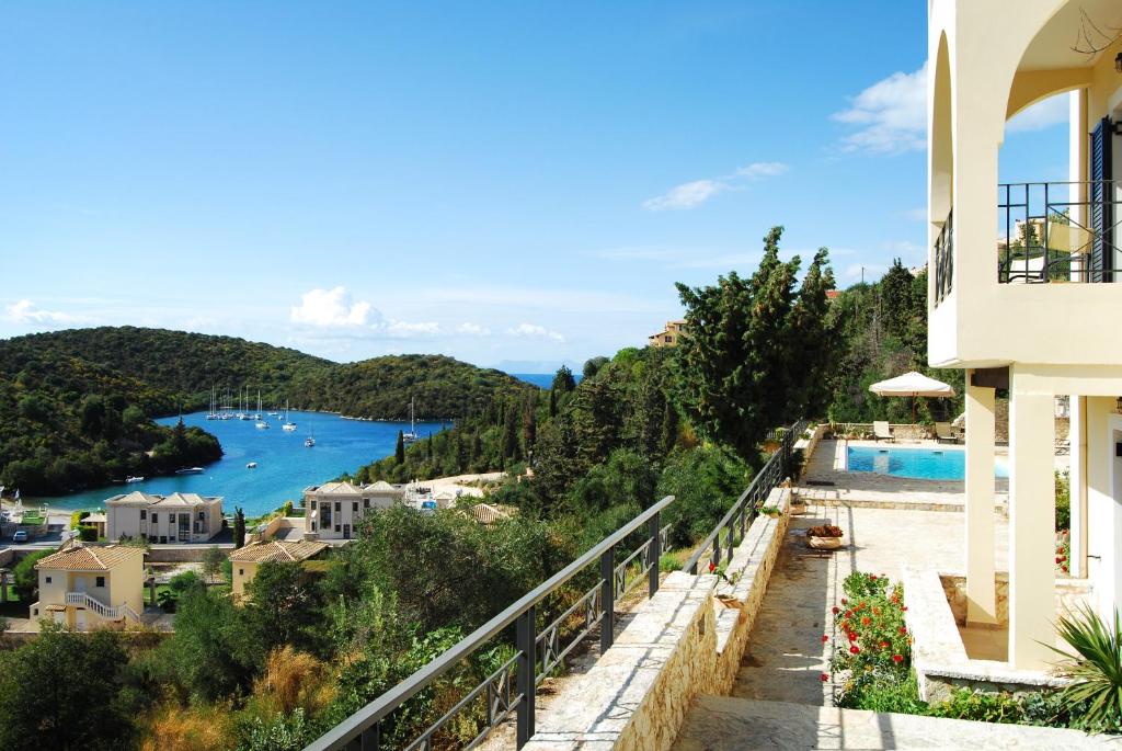 a balcony of a house with a view of the water at Niriides Luxury Apartments in Syvota