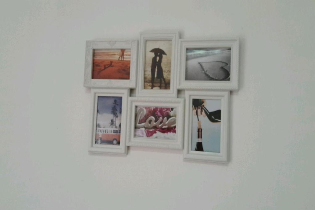 a group of pictures hanging on a wall at Guest House Oleander in Petrovac na Moru