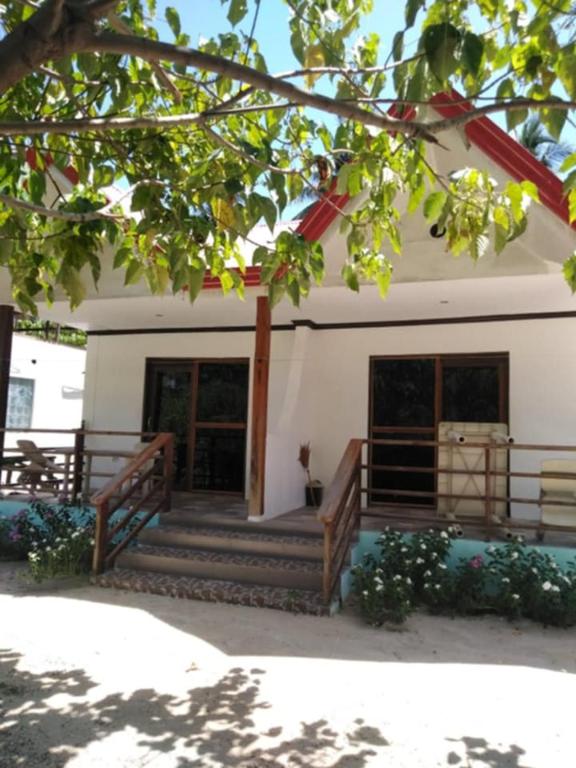 a house with a staircase in front of it at Kiera Homestay in General Luna