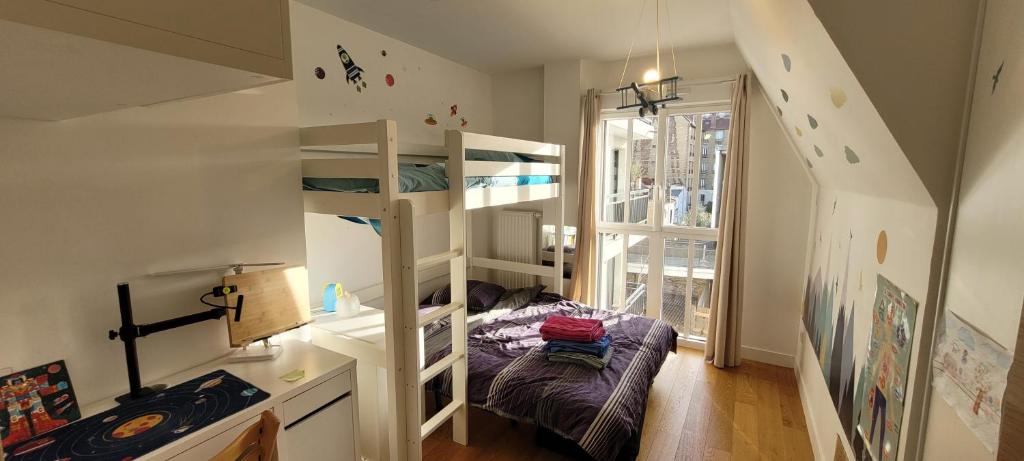 a small room with bunk beds and a staircase at Chic & Cosy apartment - 60m2, 3 rooms in Asnières-sur-Seine