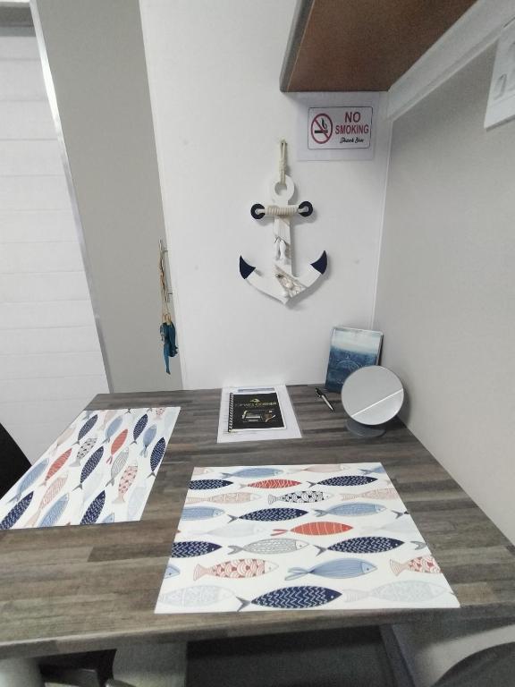 a dining room with a table with a anchor on the wall at Anreith Close in West Point