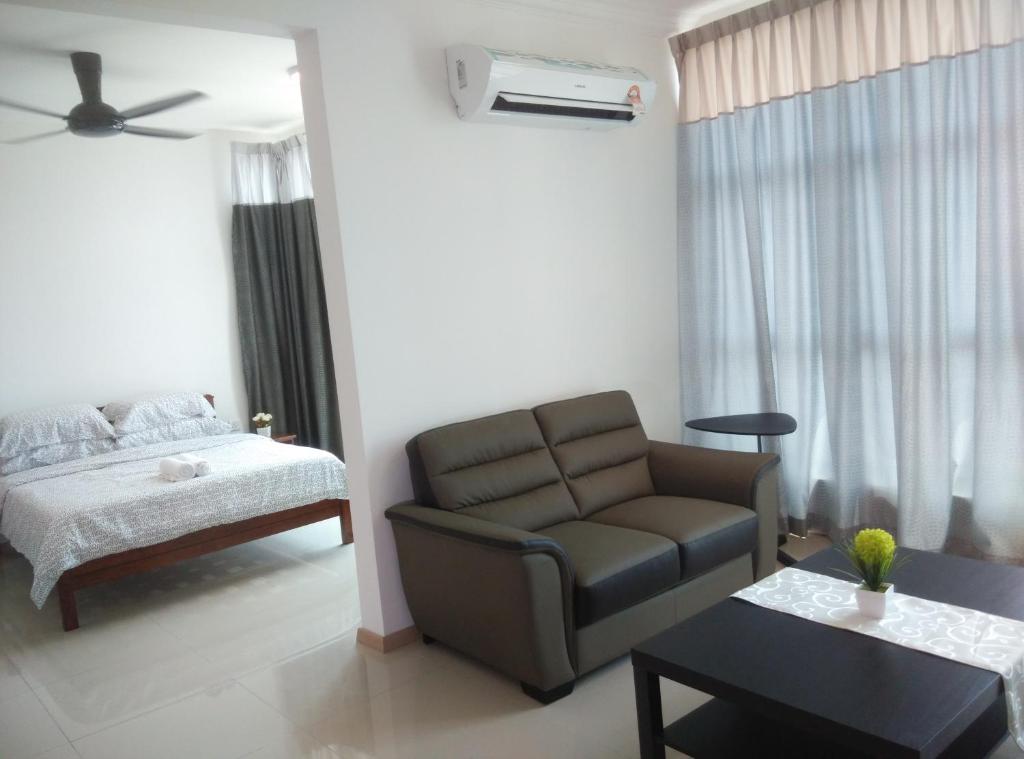 a living room with a couch and a bed at Vista Alam P Big Studio in Shah Alam