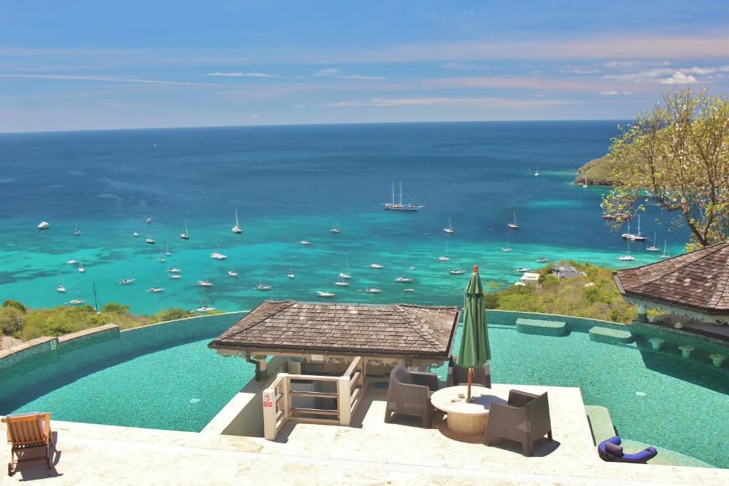 a swimming pool with a view of the ocean at Tropical Hideaway in Port Elizabeth