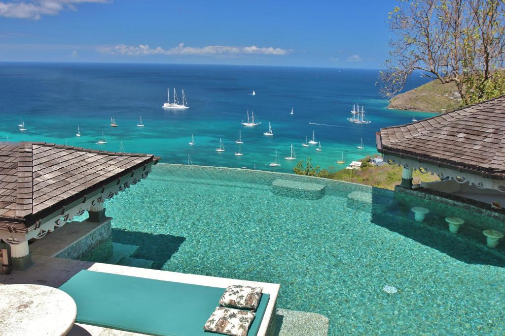 a swimming pool with a view of the water at Tropical Hideaway in Port Elizabeth