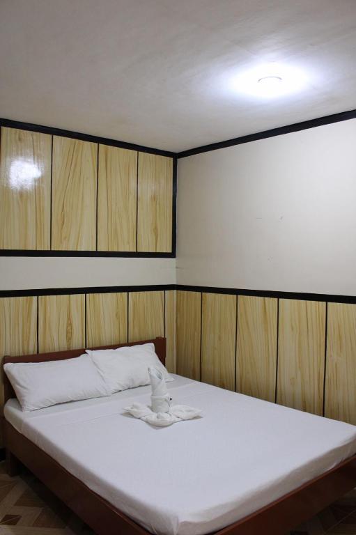 Postel nebo postele na pokoji v ubytování Agustin El Nido Inn